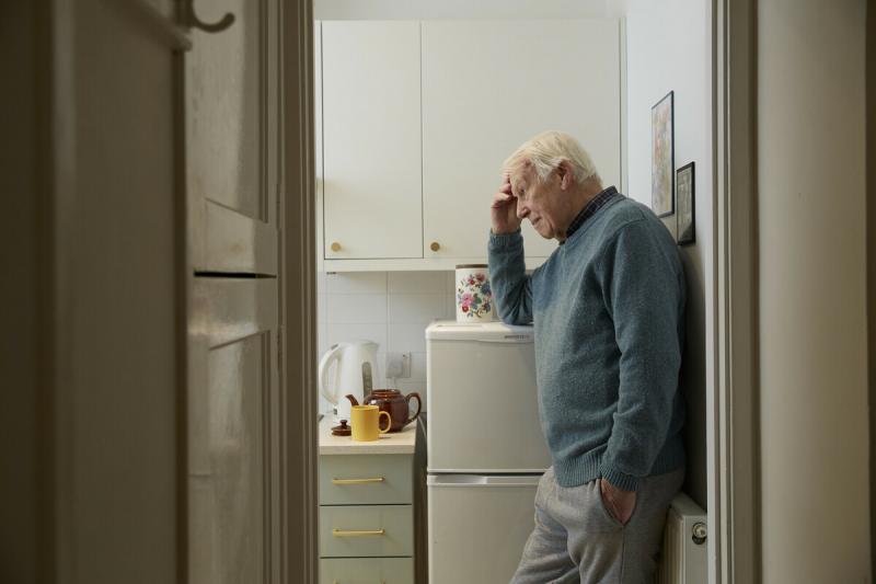 A man on his own in the kitchen.